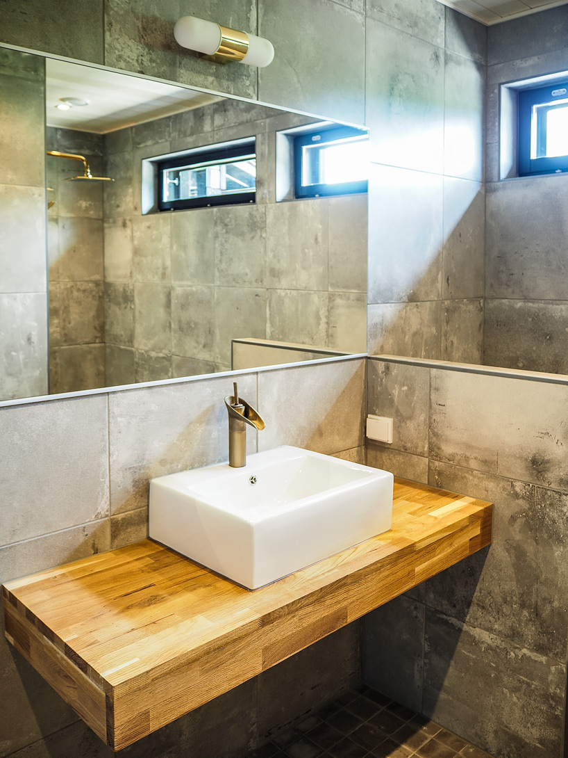 Completed bathroom with concrete-toned tiles and timber vanity