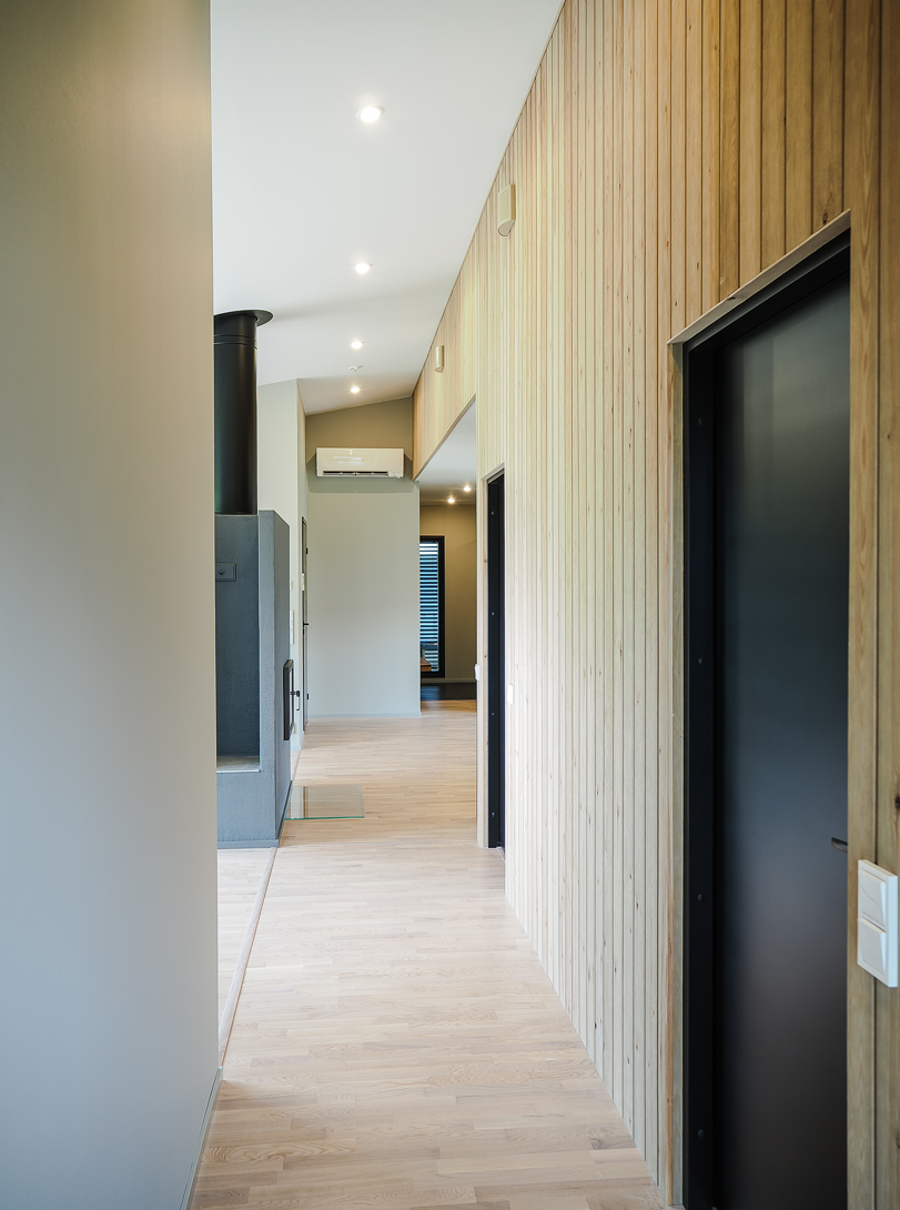 Completed corridor with timber wall and a long internal view